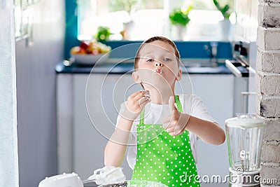 Child preparing sweet dessert and snacking strawberry Stock Photo