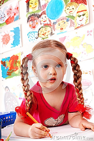 Child preschooler with pencil in play room. Stock Photo