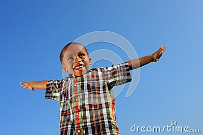 Child Pretending to Fly Stock Photo