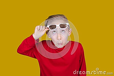 Child pulls on the forehead of children`s 3D glasses and makes funny faces Stock Photo