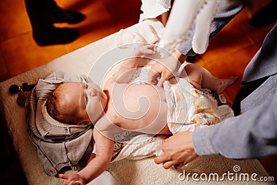 The child is put on clothes on a table in the Church. the ordinance of baptism. Stock Photo