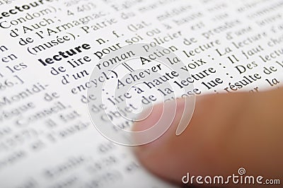Child reading with his finger on dictionary Stock Photo