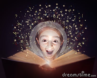 Child reading a magic story book Stock Photo