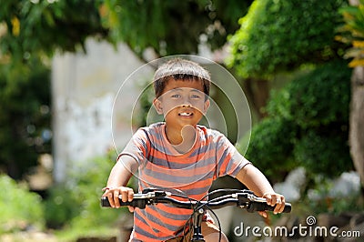 Child Riding Bicycle Stock Photo