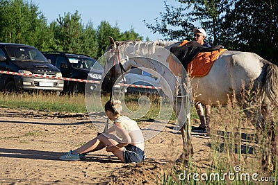 Child riding a horse in meadow in spring - Russia Berezniki 21 July 2018 Editorial Stock Photo