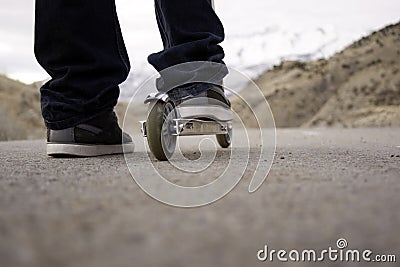 Child riding scooter on path Stock Photo