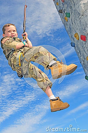 Child on rock climbing wall Stock Photo