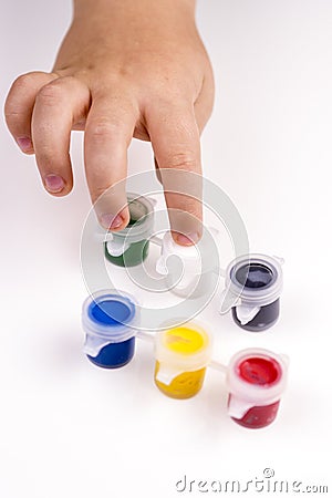 Child's finger is showing white colour of school tempera paints Stock Photo