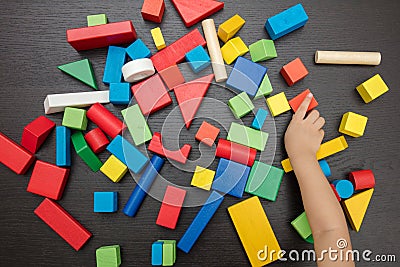 Child`s hand close up playing building blocks Stock Photo