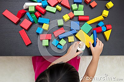 Child`s hand close up playing building blocks Stock Photo