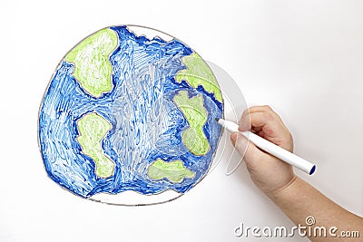 Child`s hand drawing planet Earth with a marker Stock Photo