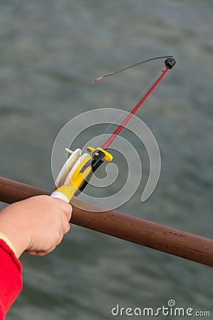 A child`s hand is fishing on a small fishing rod. Ozernaya fishing. Stock Photo