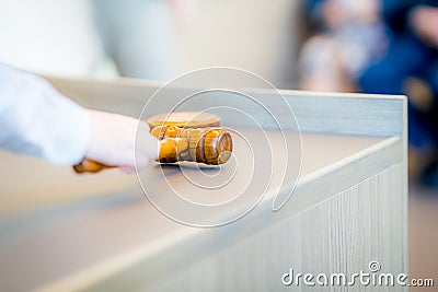 Child's hand grabs gavel of board meeting in the city council to seal marriage of his parents Stock Photo