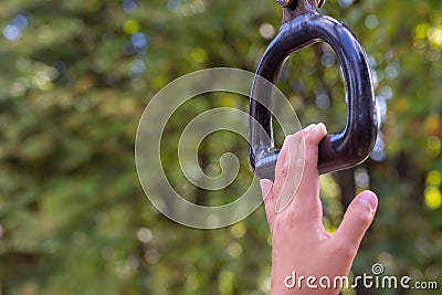 Child`s hand nearly achieving goal of grabbing a monkey bar at a playground conecept trying and striving to holding on for Stock Photo