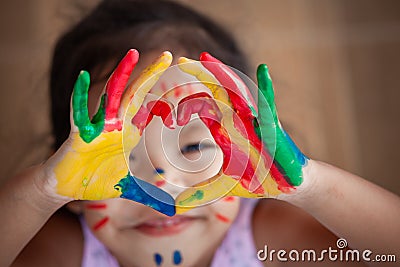 Child`s hand with painted colorful watercolor make heart shape Stock Photo