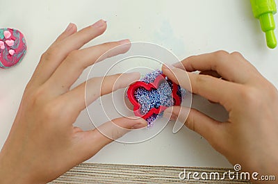 Child`s hands with colored plasticine. Stock Photo