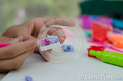 Child`s hands with colored plasticine. Stock Photo