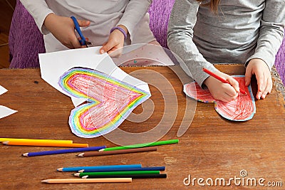 Child`s Hands are Drawing Colorful Hearts Stock Photo