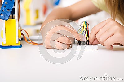 Child`s hands working with wires and circuits Stock Photo