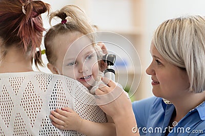 Child`s otolaryngologist doing ear examination of little girl Stock Photo