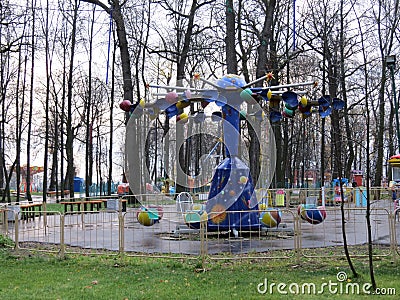 Child`s swing machine on the autumn. A toy car for children in the yard. Stock Photo