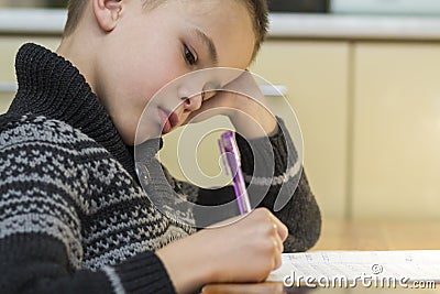 Child school age boy making his homework Stock Photo