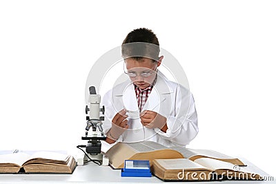 Child scientist looking at microscope slide Stock Photo