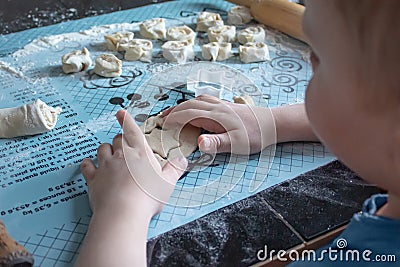 Child sculpts cookies from the dough, hands closeup Stock Photo