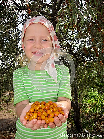 The child with sea-buckthorn berries Stock Photo