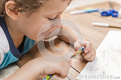 Child sharpening a pencil. Stock Photo