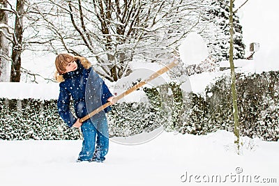 Child shoveling winter snow. Kids clear driveway Stock Photo