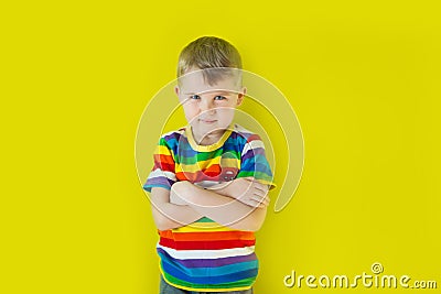 A grim, hurt child stands near the wall. Green background. Stock Photo