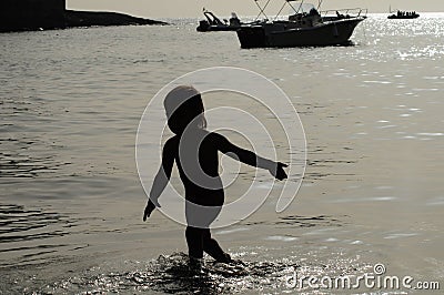 Child silhouette at sea Stock Photo