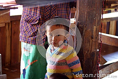 Child at a silk factory Editorial Stock Photo