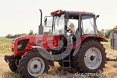 Child sitting in the cabin tractor Stock Photo