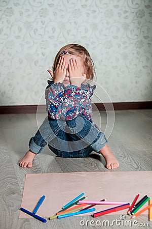 Child sitting on the floor Stock Photo