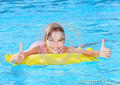 Child sitting on inflatable ring thumb up. Stock Photo