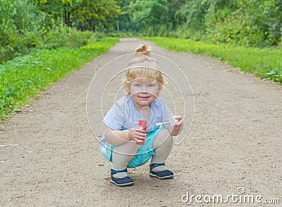 A child sitting on the street in the Park. Stock Photo