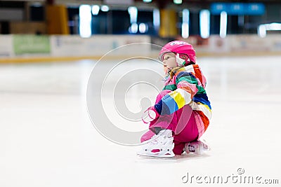 Child skating on indoor ice rink. Kids skate Stock Photo