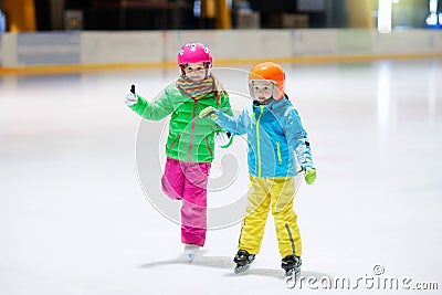 Child skating on indoor ice rink. Kids skate Stock Photo