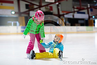 Child skating on indoor ice rink. Kids skate Stock Photo