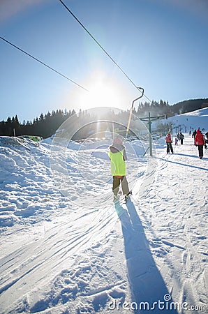 Child in ski lift in winter resort Editorial Stock Photo