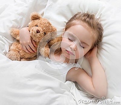 Child sleeping with a cute teddy bear Stock Photo