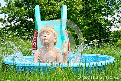 Child Sliding into Pool Stock Photo