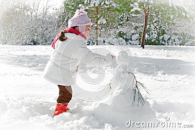 Child and snowman Stock Photo