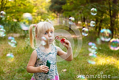 Child and soap bubbles in summer Stock Photo