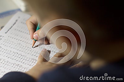 Child solves mathematics examples. Stock Photo