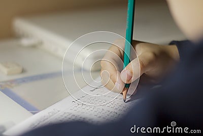 Child solves mathematics examples. Stock Photo