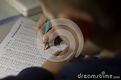 Child solves mathematics examples. Stock Photo