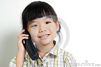 Child speaking on the phone Stock Photo